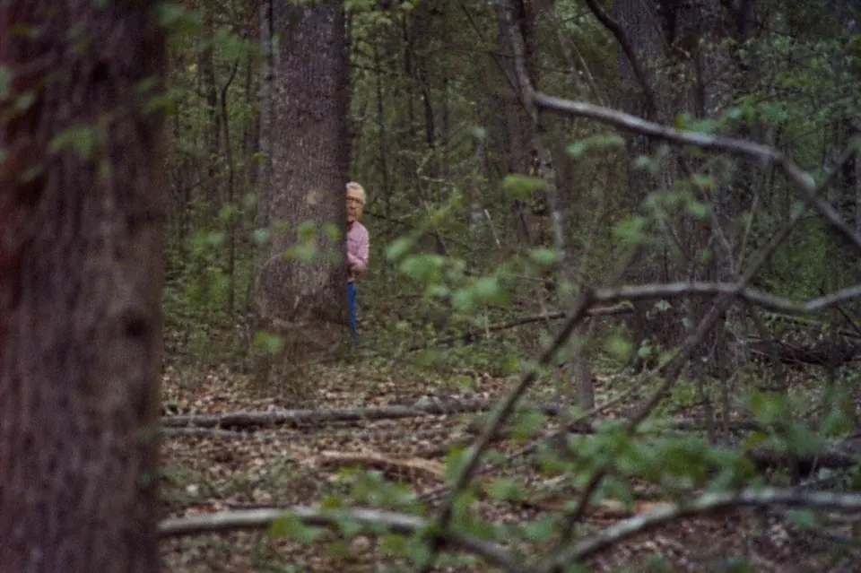 Satirical fake sighting of a Mitch-like figure peeking from behind a tree